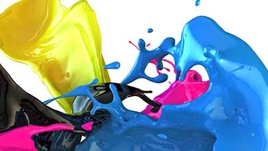 Dynamic splash of liquid colorants in blue, yellow, pink, and black against a white background.